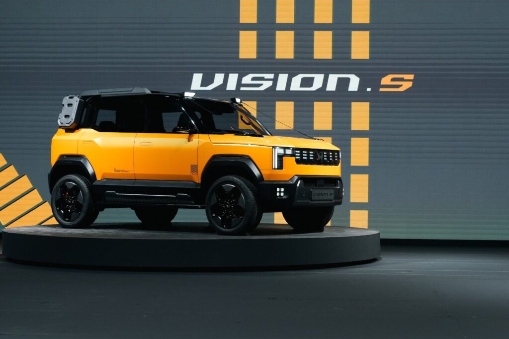 Mahindra Vision S yellow car, yellow and grey background