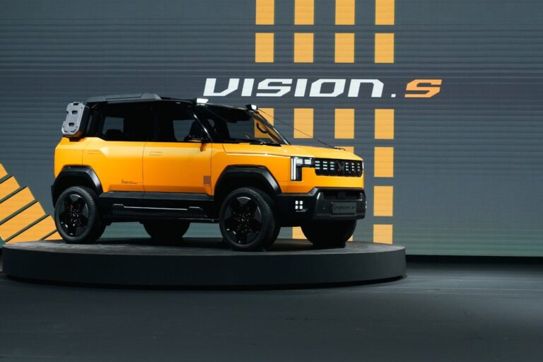 Mahindra Vision S yellow car, yellow and grey background